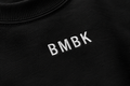 Black sweatshirt with 'BMBK' embroidered on it