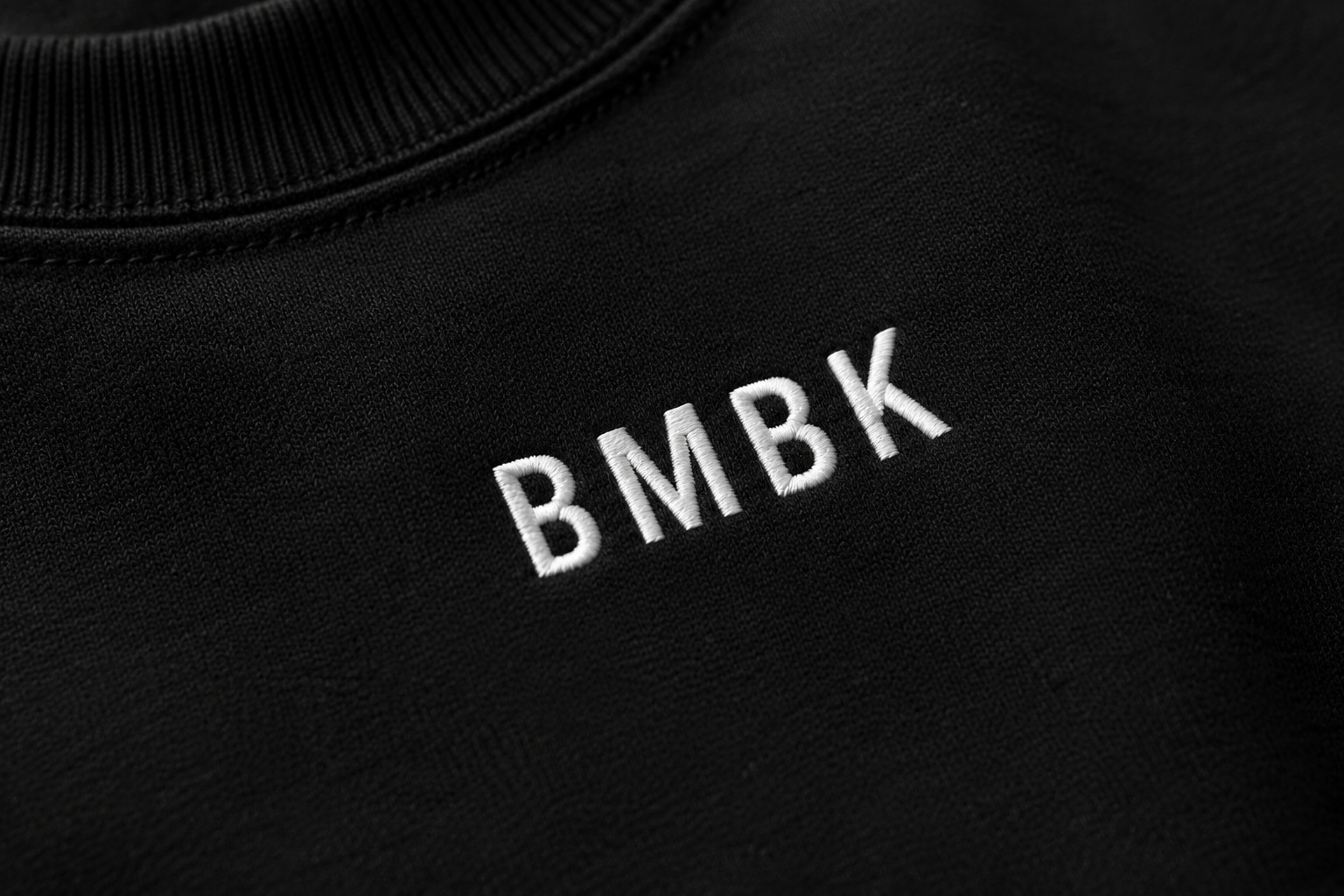 Black sweatshirt with 'BMBK' embroidered on it
